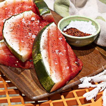 Aleppo Pepper and sea salt sprinkled on watermelon slices and in bowl.