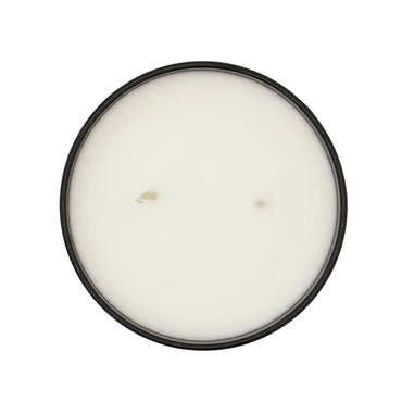 Round candle with an amber vessel on a white background