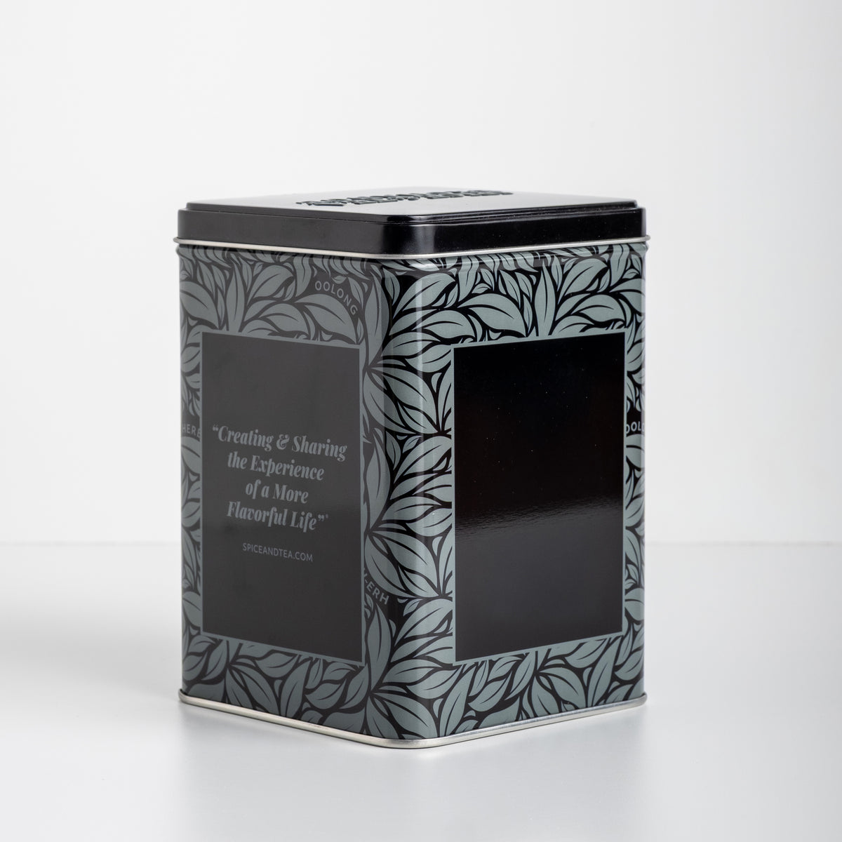 Decorative black grey and silver tea tin with leaf pattern on a white background. With text: Creating & Sharing the Experience of a More Flavorful Life spiceandtea.mom