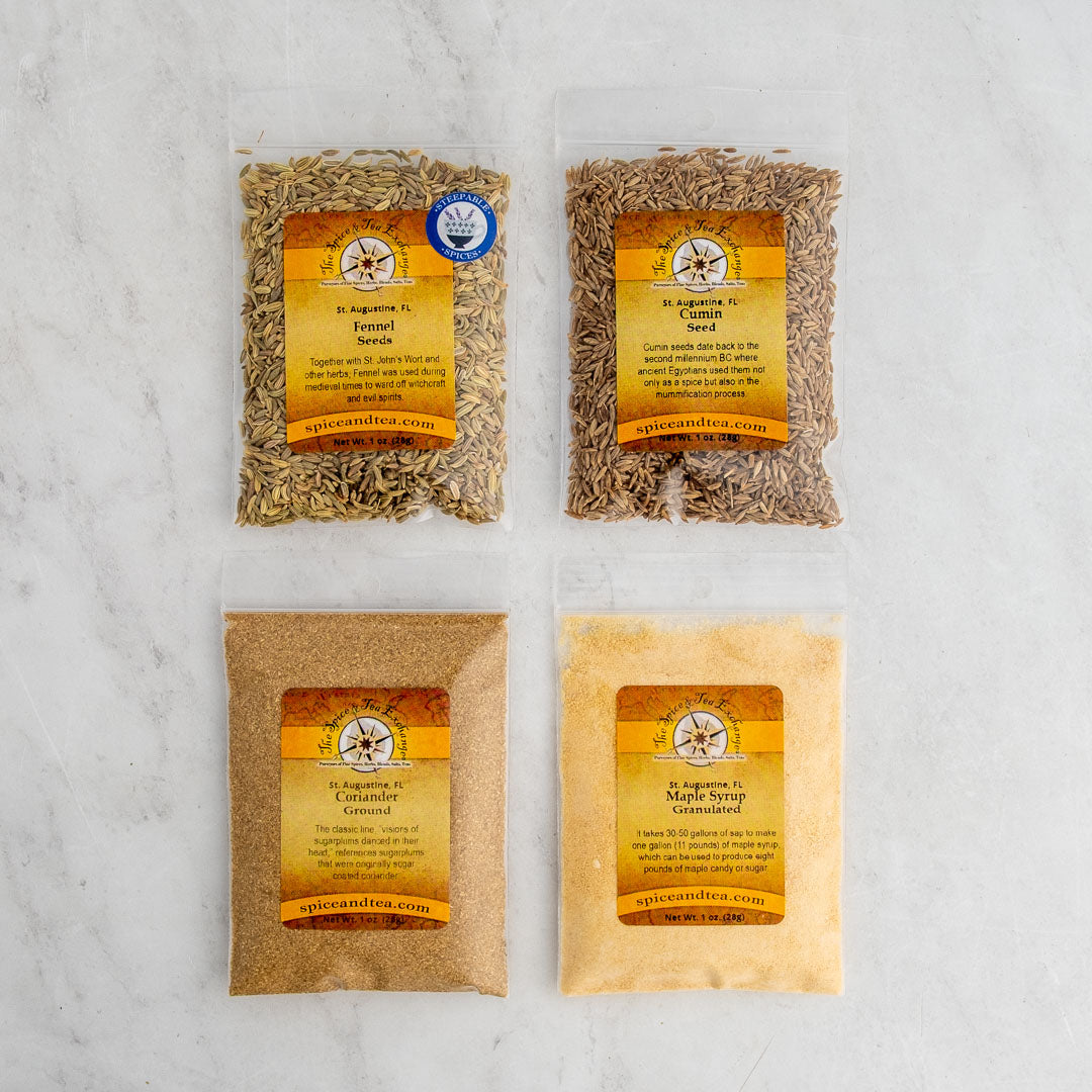 The Self Care Sipper Sampler includes Argentinian fennel seed, caraway seed, Saigon cinnamon (ground), and maple syrup granulated packets—each with a yellow-orange label—ideal for your daily ritual or Self Care Sipper routine.