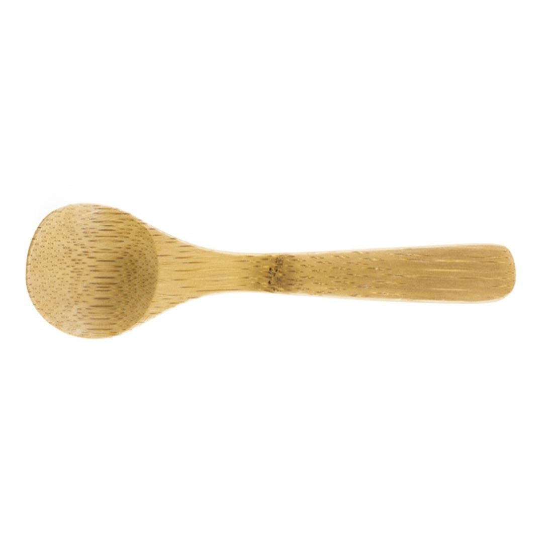 The Bamboo Salt Spoon Mini is a small, light brown spoon made from Moso bamboo with a rounded bowl and flat, textured handle—an elegant addition to your salt accessories, shown on a white background.