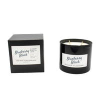Black candle with 'Blueberry Black' label and matching black box on a white background