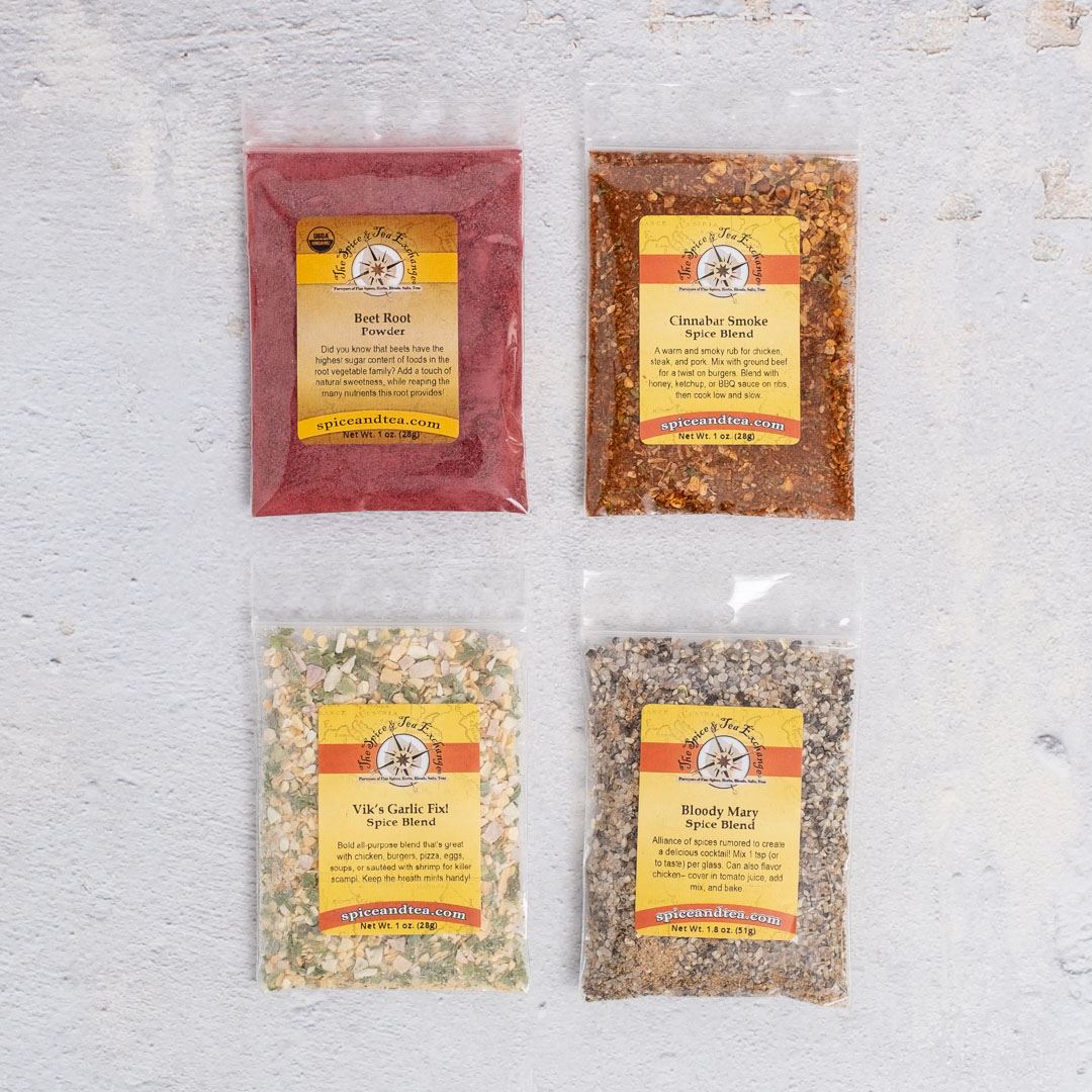 The Burger Seasonings Sampler features four clear packets with yellow labels: Beet Root, Clambake Smoke, Viki's Garlic Hut, and Bloody Mary—each a unique blend perfect for your next grilling night.