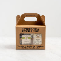 The Chocolate Lover's Gift Box is a brown cardboard box with a handle, labeled The Spice & Tea Exchange, containing Chocolate Chai tea and Dark Cocoa sugar—perfect cocoa blends. Features the slogan: Creating & Sharing the Experience of A More Flavorful Life.