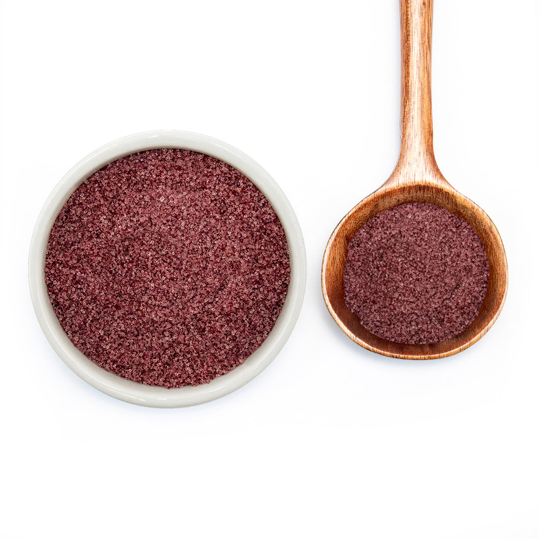 Cranberry Orange Monk Fruit Sweetener in white bowl and on wooden spoon