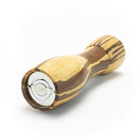 A distinctive kitchen gift, the 8" Crushed Bamboo Pepper Mill showcases a natural wood grain and rests on its side, revealing its metal grinder and "core" engraved on the base.