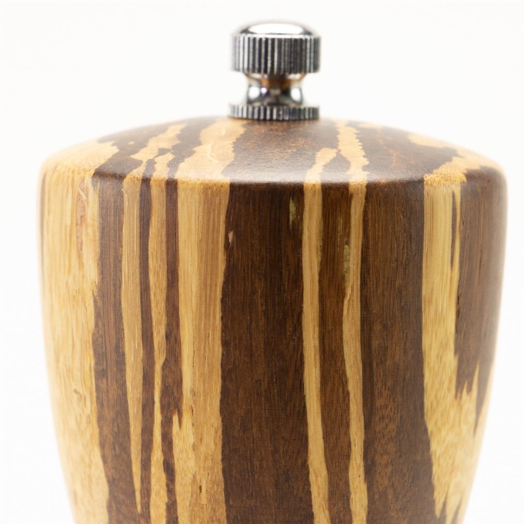 Close-up of the top of the 8" Crushed Bamboo Pepper Mill with a metal knob, highlighting its natural wood grain and striped light and dark brown bamboo pattern.
