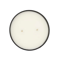 A top-down view of the Earl Grey Candle—a round, natural soy candle with two unlit wicks in a black container on a white background—infused with the calming aroma of Earl Grey Black Tea essential oils.