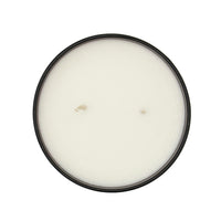 Round candle with an amber vessel on a white background