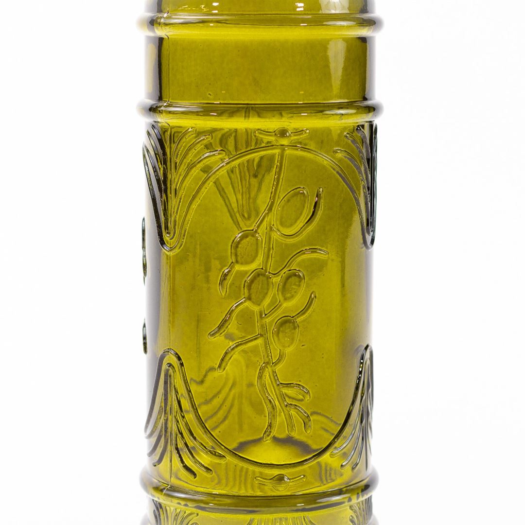 A close-up of the Olive Glass Oil Jar, a decorative green glass bottle with an embossed design of olive branches and olives on the front.