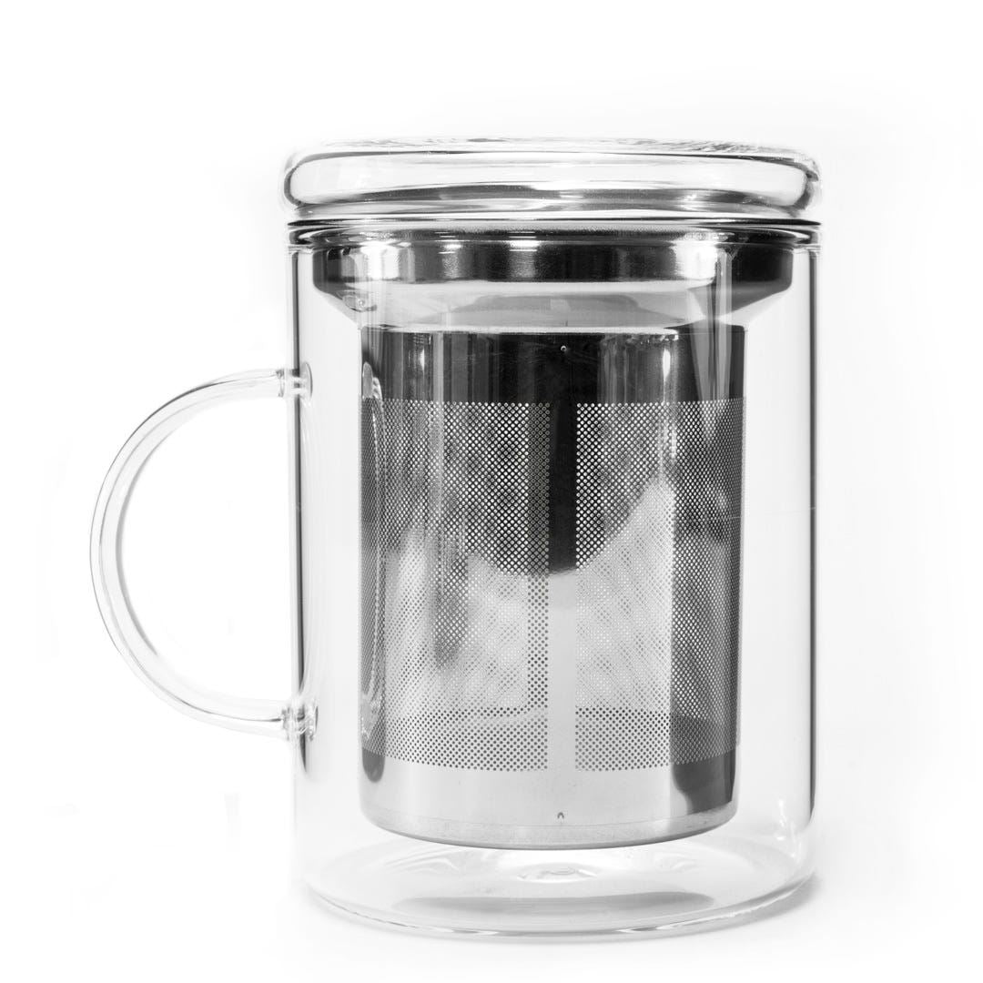 The Glass Tea Mug Infuser is a clear, heat-resistant glass mug with a handle, featuring a stainless steel infuser and matching glass lid, shown against a white background.