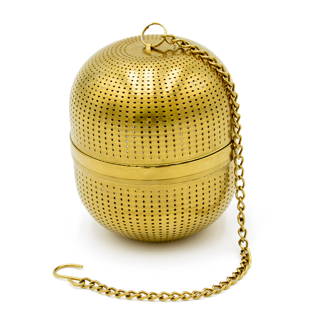 The Gold Ball Infuser - Large features a gold finish, small perforations, a hinged center, and a chain with hook for easy use.