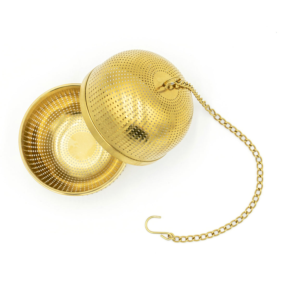 The Gold Ball Infuser - Large features small perforations and an attached chain with a hook. Shown open, it's perfect for brewing your favorite loose-leaf teas.