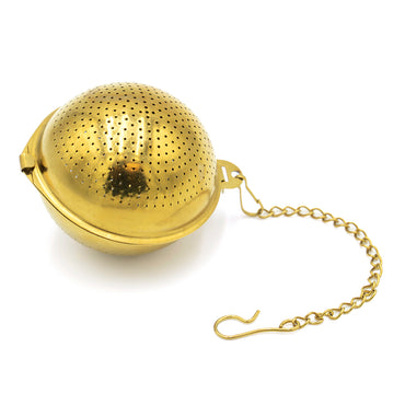 The Gold Ball Infuser - Small is a gold-colored, spherical stainless steel tea infuser featuring small perforations and a chain with a hook for hanging.