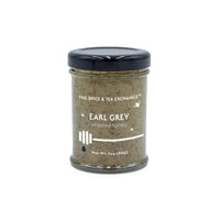 The Earl Grey Whipped Honey Jar from The Spice & Tea Exchange is a 3oz (85g) glass jar with a black lid, featuring creamy natural honey infused with Earl Grey flavor and a honey dipper illustration on the label.