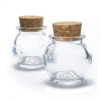The Glass Jar Honey Pot with Cork features two small, round glass jars with wide mouths and cork lids, perfect for storing spices, shown on a white background.