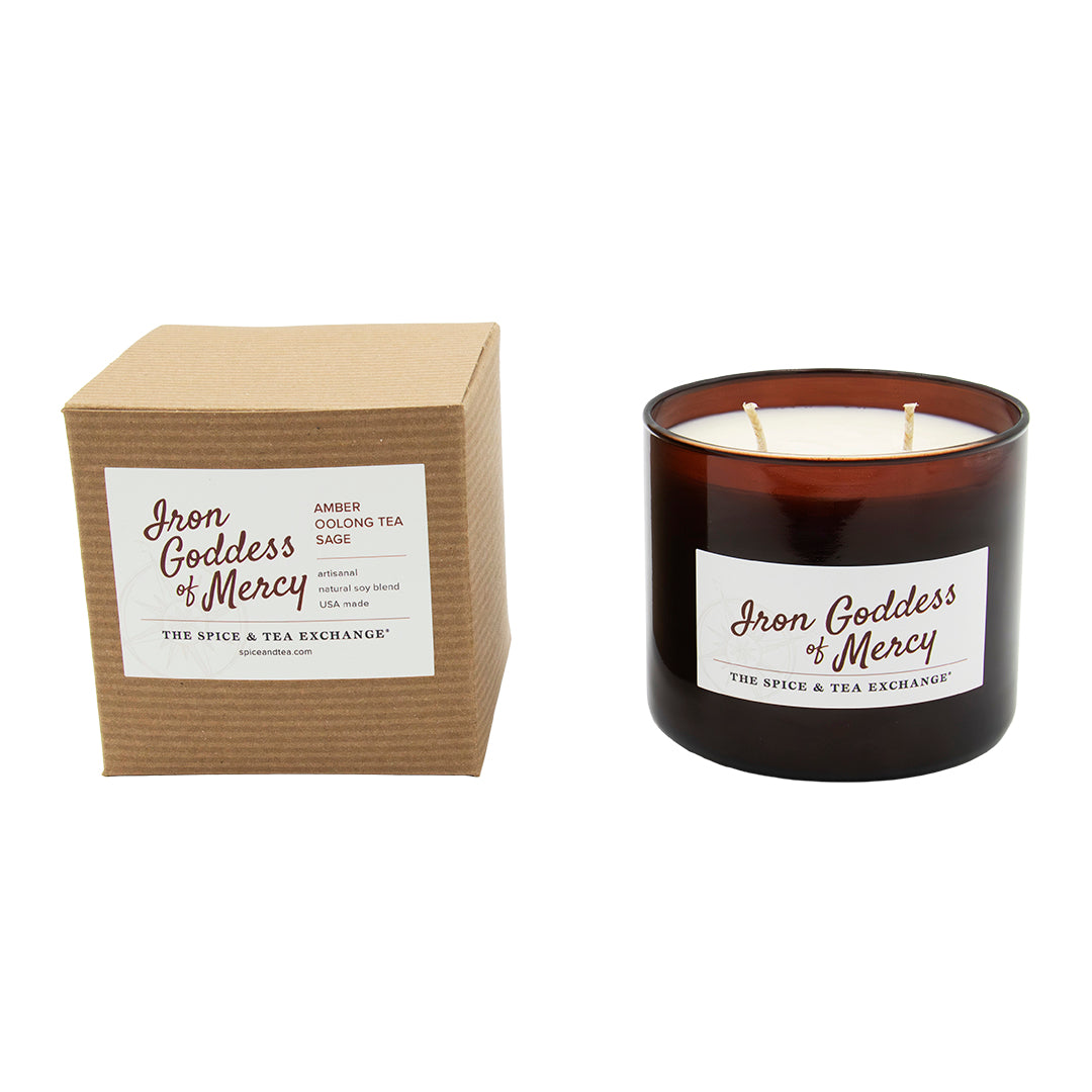 Candle with 'Iron Goddess of Mercy' label and matching brown box on a white background