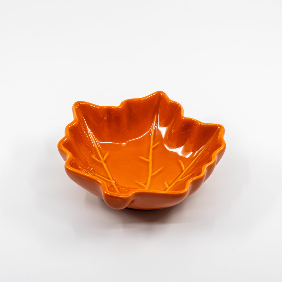 Orange leaf-shaped bowl on a white background