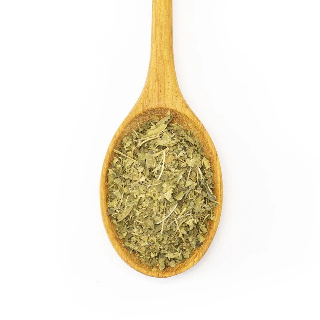 A wooden spoon filled with Organic Lemon Verbena—ideal for herbal tisanes or as a lemon zest substitute—rests on a plain white background.