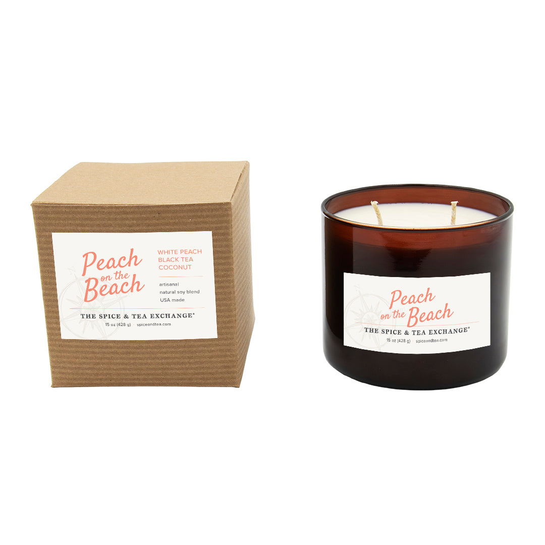 Candle with packaging labeled 'Peach on the Beach' by The Spice & Tea Exchange on a white background.