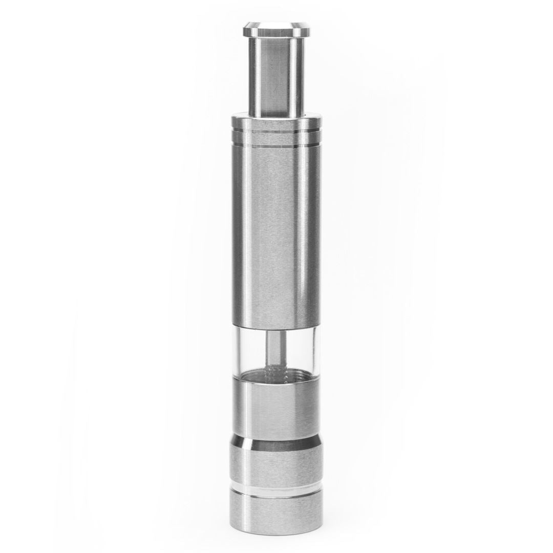 The Pump & Grind Salt & Pepper Mill is a compact, cylindrical grinder with a stainless steel and glass body and an easy push-top, shown standing upright against a plain white background.