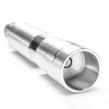 A close-up image of a compact Pump & Grind Salt & Pepper Mill lying on its side against a white background, highlighting the lens-like top and cylindrical metal body.