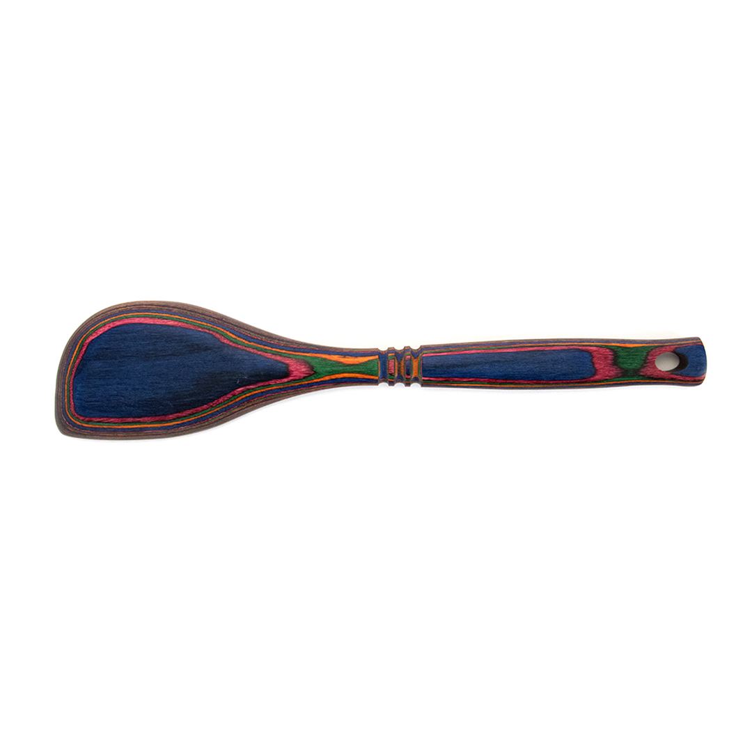 The Rainbow Corner Spoon is a moisture-resistant wooden spatula with a rounded flat blade and a handle crafted from layered blue, red, green, and yellow pakkawood. It includes a hole at the end for easy hanging.