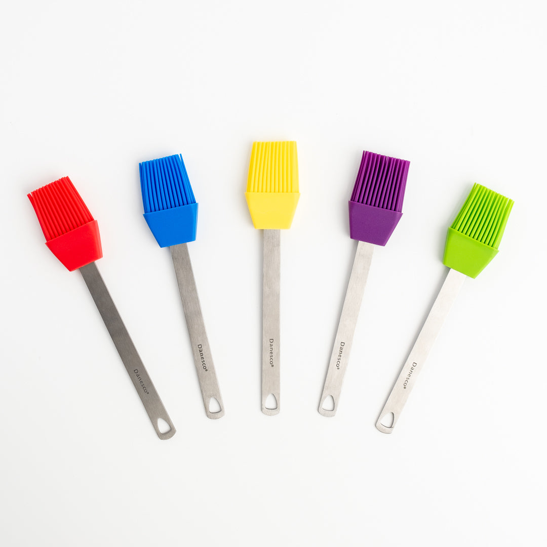 Five Mini Basting Brushes with stainless steel handles are lined up on a white background. Each silicone brush head is a different color: red, blue, yellow, purple, and green—ideal grilling gifts for any occasion.