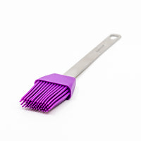 The Mini Basting Brushes feature a purple silicone head and bristles with a stainless steel handle, shown on a white surface—ideal for grilling gifts or enhancing your basting brush collection.