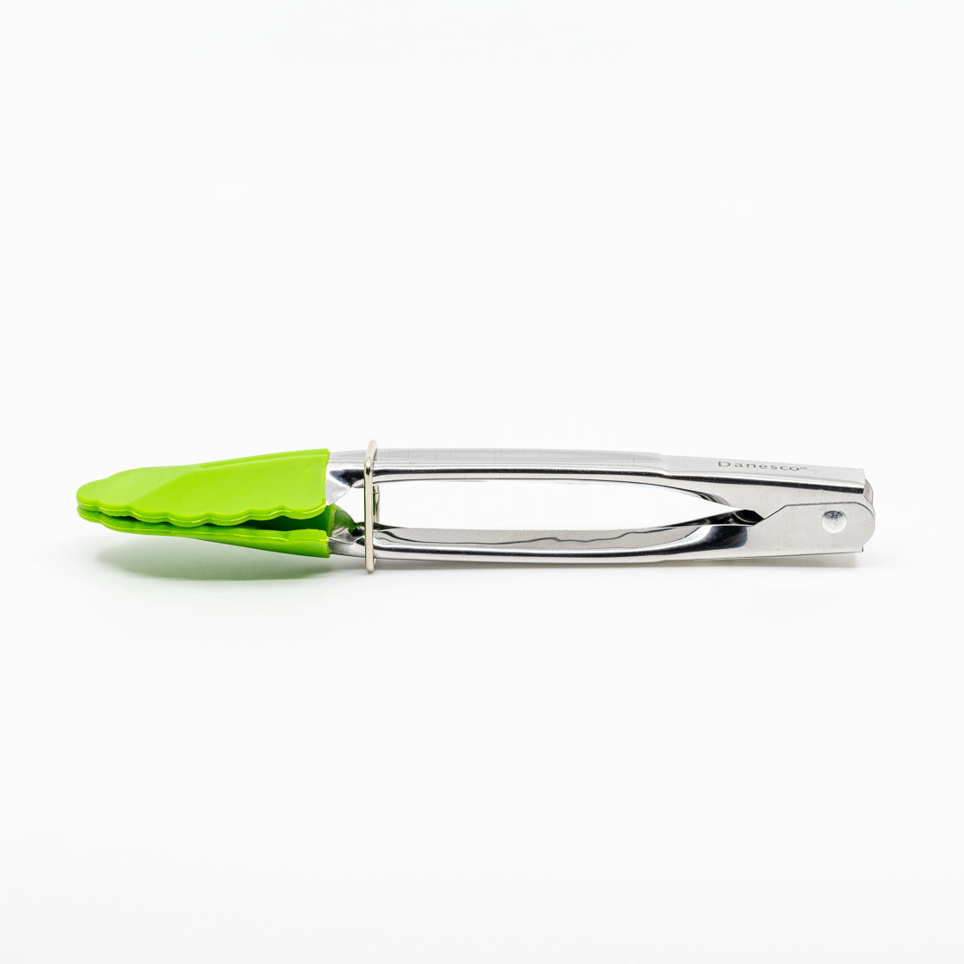 A pair of Mini Tongs with green silicone tips and a stainless steel handle are closed and resting on a white background.