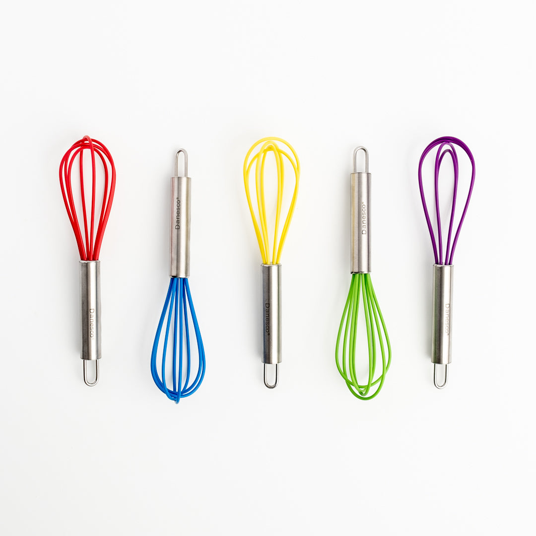 Five Mini Whisks with metal handles and heat-resistant silicone wires in red, blue, yellow, green, and purple are neatly arranged in a row on a white background.