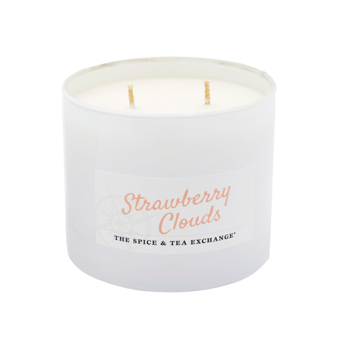 White candle with 'Strawberry Clouds' text on a white background