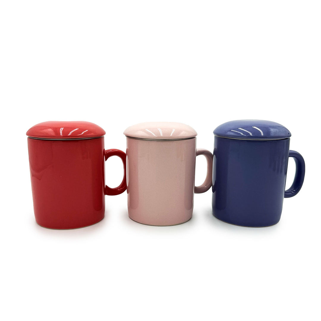 Three ceramic mugs with lids in red, pink, and blue on a white background