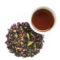 A cup of Victorian Chai Tea sits beside dried flowers, filling the air with warm spices and delicate floral notes.