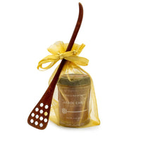 The Honey Jar with Dipper - Arbol includes a glass spice jar labeled Arbol Chile in a yellow organza gift bag with ribbon, beside a honeycomb wood dipper—ideal for pairing arbol honey or drizzling raw natural honey.